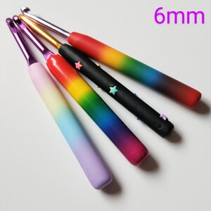 May include: Five rainbow crochet hooks with star embellishments. The hooks are 6 mm in size.