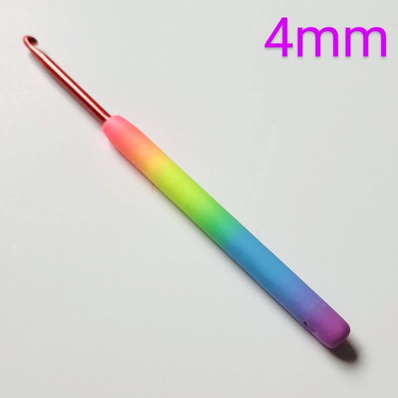 May include: A 4 mm rainbow crochet hook with a red metal hook and a rainbow gradient handle.