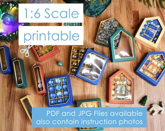 May include: A set of 1:6 scale printable Christmas ornament boxes. The boxes are made of cardboard and are decorated with a variety of colors and patterns. The boxes are designed to hold small ornaments, such as glass balls, stars, and bells. The boxes are also decorated with the text "1:6 Scale printable".