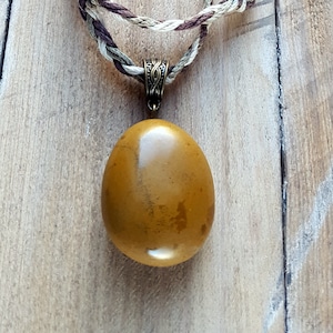 Hand-polished beach pebble pendant necklace, natural stone, braided hemp cord