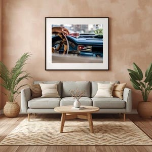 Puede incluir: Una impresión artística enmarcada que muestra el interior de un coche azul antiguo, con un volante, un salpicadero con el emblema de la bandera cubana y un letrero de taxi verde visible a través del parabrisas, en un marco negro.
