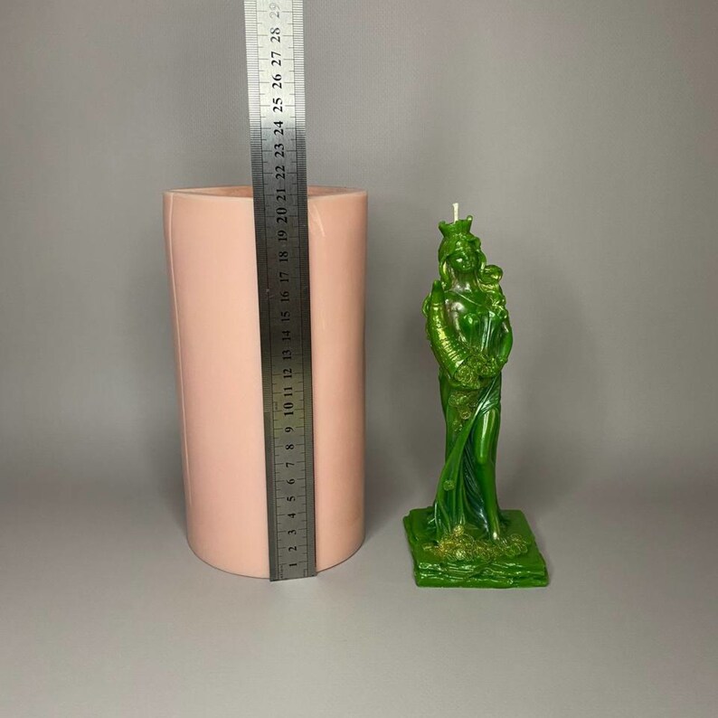 May include: A pink silicone mold for making candles in the shape of a green goddess statue. The mold is 18 inches tall and the statue is about 15 inches tall.