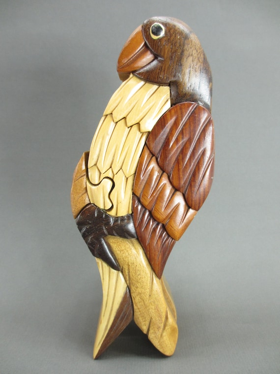 A hand-carved wooden parrot that's secretly a puzzle box with a hidden compartment lined in red velvet — functional folk art with a satisfying 'aha' moment.