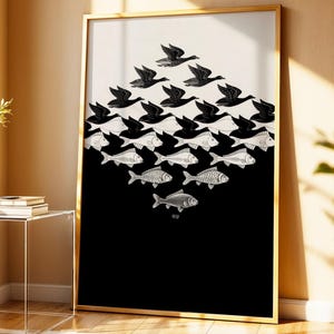 May include: A framed art print featuring a black and white optical illusion. The design shows a flock of birds transitioning into a school of fish. The artwork is set against a black and cream background, framed in gold.