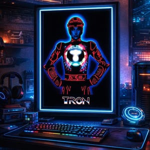 May include: A digital art piece featuring a computer setup with a glowing blue-bordered screen displaying a Tron-themed image. The image shows a figure in a Tron suit, with the word "TRON" below. A keyboard, mouse, and headphones are visible.