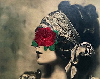 May include: A vintage photograph of a woman wearing a headscarf with a red rose embroidered over her eye. The woman is wearing a patterned blouse and has her hair styled in a bun.