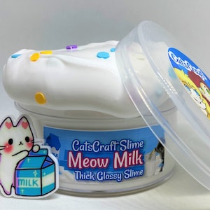 May include: White slime with colorful sprinkles in a clear plastic container with a lid. The container has a label that says "CatsCraft Slime Meow Milk Thick Glossy Slime".