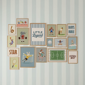 May include: A collection of framed art prints featuring sports-themed illustrations. The prints showcase various sports like baseball, basketball, soccer, and surfing, with animal characters. The color palette includes blues, greens, and browns, with text like "STAR" and "BOYS RULE".