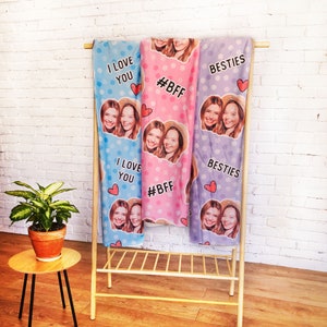 May include: Three personalized fleece blankets with different designs. The first blanket is light blue with white polka dots and the text "I love you". The second blanket is pink with white polka dots and the text "#BFF". The third blanket is light purple with white polka dots and the text "Besties".