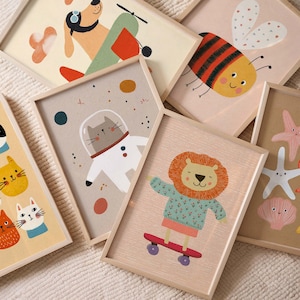 May include: A collection of framed art prints featuring whimsical animal illustrations. The prints include a dog in a plane, a bee, a cat in a spacesuit, a lion on a skateboard, and other sea creatures. The frames are light wood.