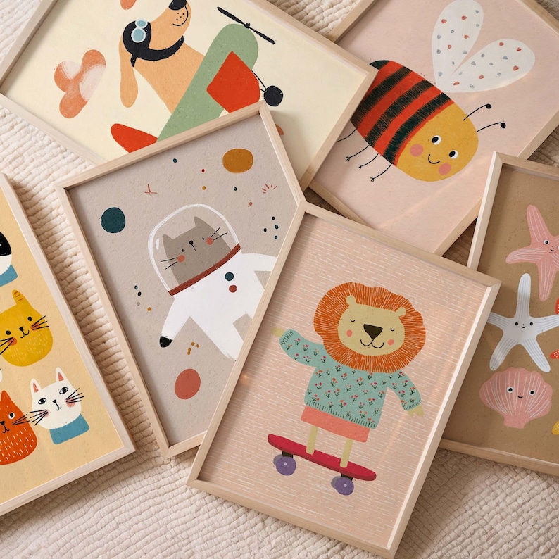 May include: A collection of framed art prints featuring whimsical animal illustrations. The prints include a dog in a plane, a bee, a cat in a spacesuit, a lion on a skateboard, and other sea creatures. The frames are light wood.