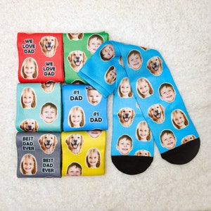 May include: Set of eight colorful socks featuring different images of dogs and children. The socks have the text "We Love Dad", "Best Dad Ever", and "#1 Dad" printed on them.