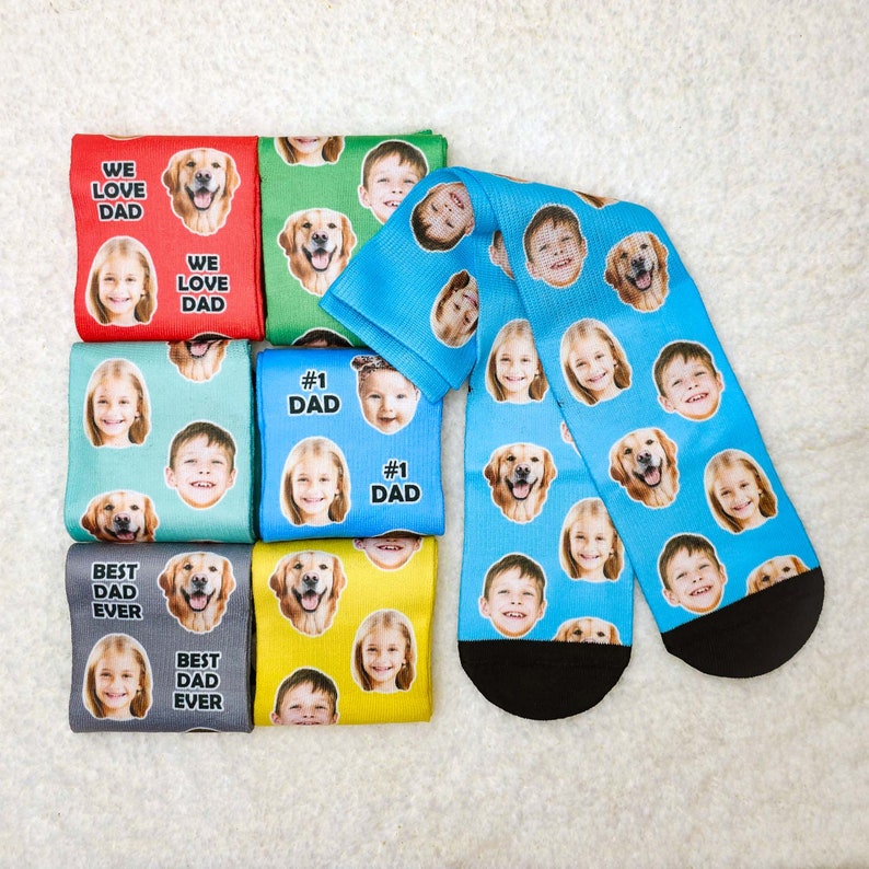 May include: Set of eight colorful socks featuring different images of dogs and children. The socks have the text "We Love Dad", "Best Dad Ever", and "#1 Dad" printed on them.