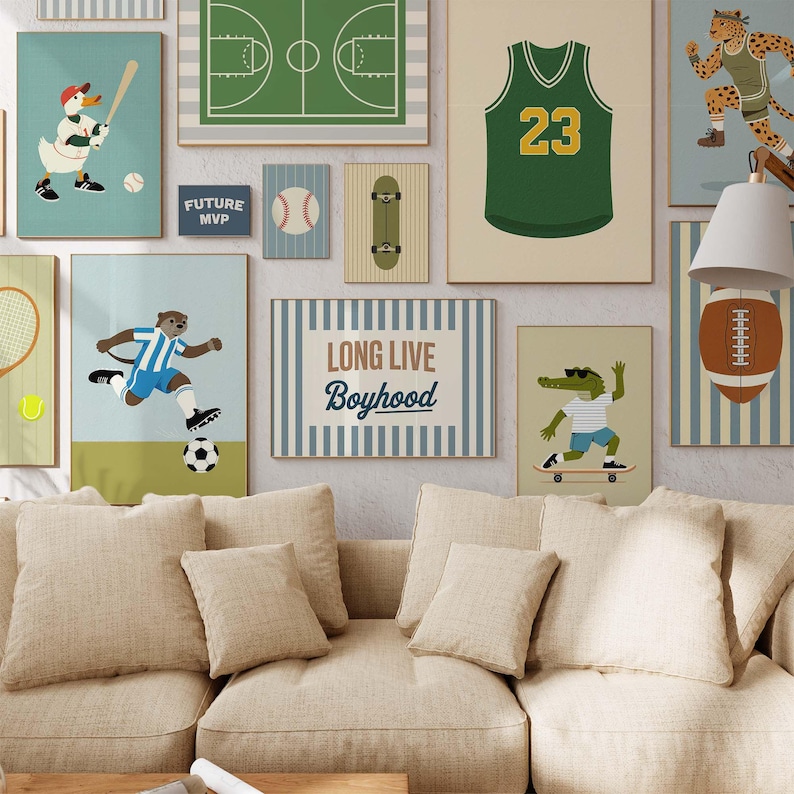 May include: A collection of framed art prints featuring sports themes. The prints include a basketball court, a football jersey with the number 23, a baseball, a skateboard, and a soccer player. The phrase "LONG LIVE Boyhood" is also displayed.