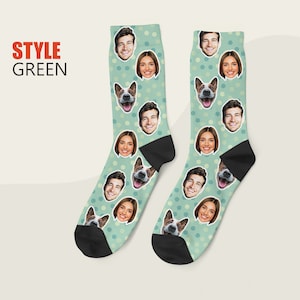 May include: A pair of green socks with white polka dots. The socks feature a repeating pattern of faces and a dog's face.
