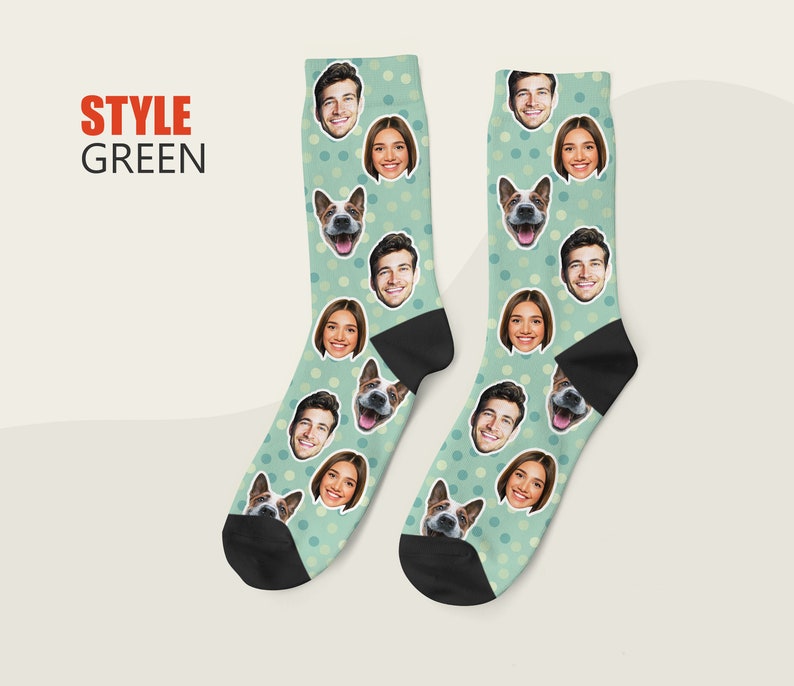 May include: A pair of green socks with white polka dots. The socks feature a repeating pattern of faces and a dog's face.