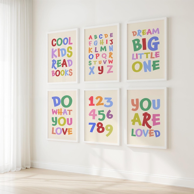 May include: Six framed art prints with colorful text on a cream background. The prints feature phrases like "COOL KIDS READ BOOKS" and "DREAM BIG LITTLE ONE", along with the alphabet and numbers.