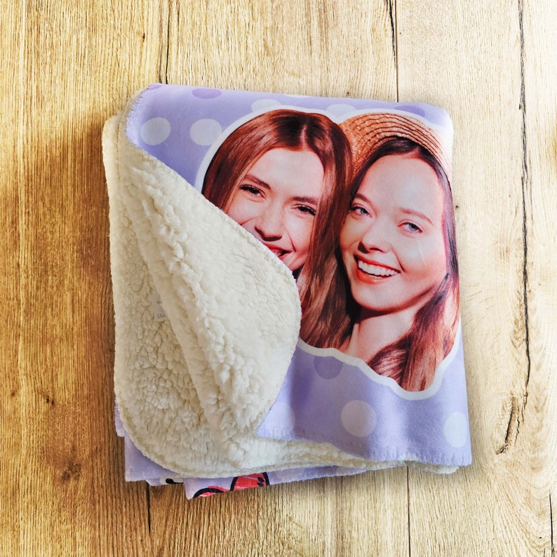 May include: A purple fleece blanket with white polka dots features a photo of two women smiling. The blanket has a white sherpa lining.