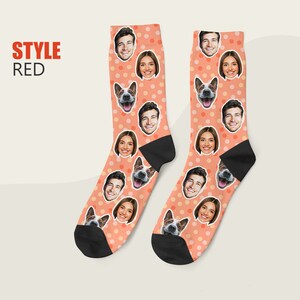 May include: A pair of orange socks with white polka dots. The socks feature a repeating pattern of faces, including people and a dog.