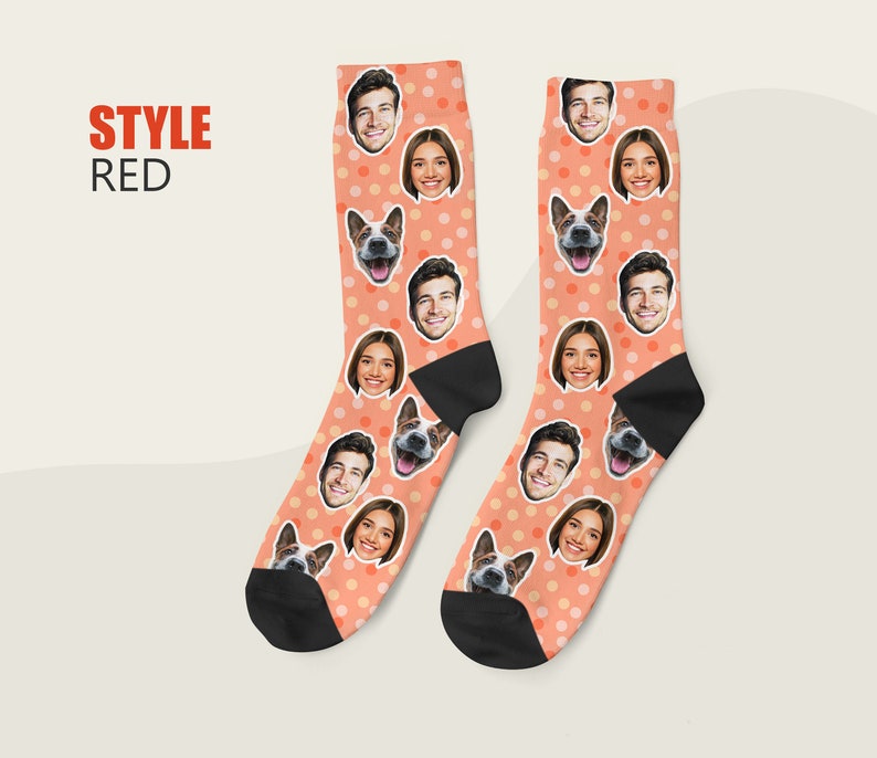May include: A pair of orange socks with white polka dots. The socks feature a repeating pattern of faces, including people and a dog.