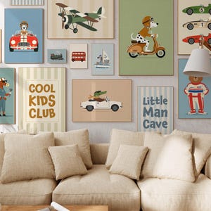 May include: A collection of framed art prints featuring whimsical illustrations. The prints depict animals driving cars, riding scooters, and flying airplanes. One print reads "Cool Kids Club," and another says "Little Man Cave."