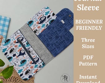 May include: A journal sleeve with a zipper closure, featuring a pattern of helicopters, clouds, and stars in blue, gray, and white. The sleeve is made of various fabrics and includes text that reads "Journal Sleeve" and "Beginner Friendly."