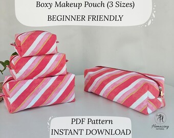 May include: Several boxy makeup pouches in various sizes, featuring a diagonal striped pattern in shades of pink, white, and gold. One pouch is laid flat, while others are stacked. The text "Boxy Makeup Pouch (3 Sizes)" and "BEGINNER FRIENDLY" is visible.