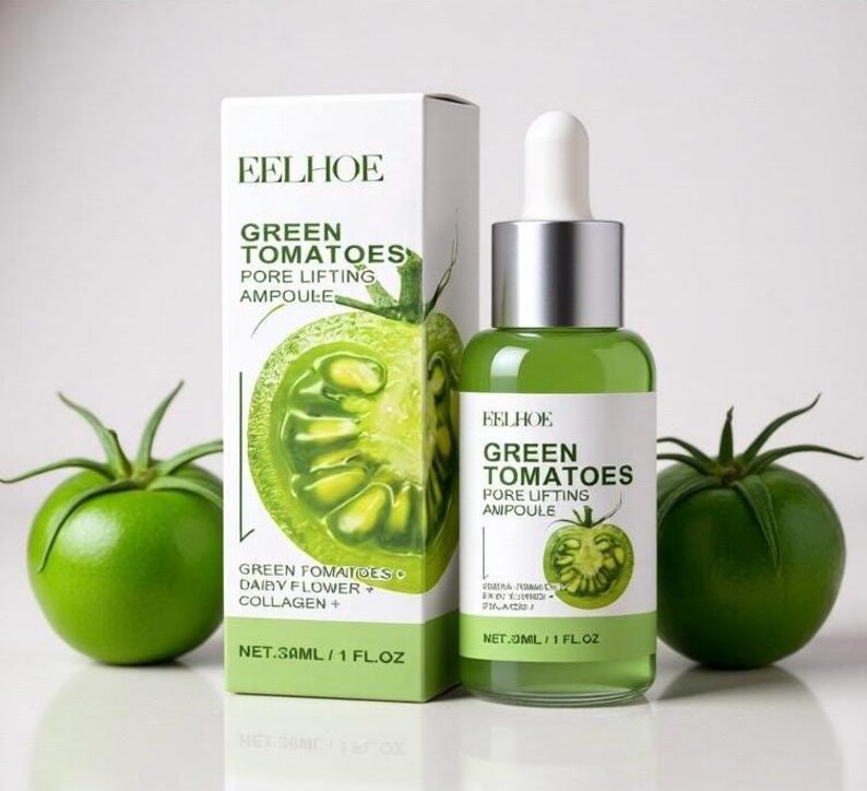 May include: A green glass bottle and a white box with the text "EELHOE GREEN TOMATOES PORE LIFTING AMPOULE" and a green tomato illustration. The bottle contains a green liquid. Two green tomatoes are on either side of the bottle and box. The box reads "NET.30ML / 1 FL.OZ."