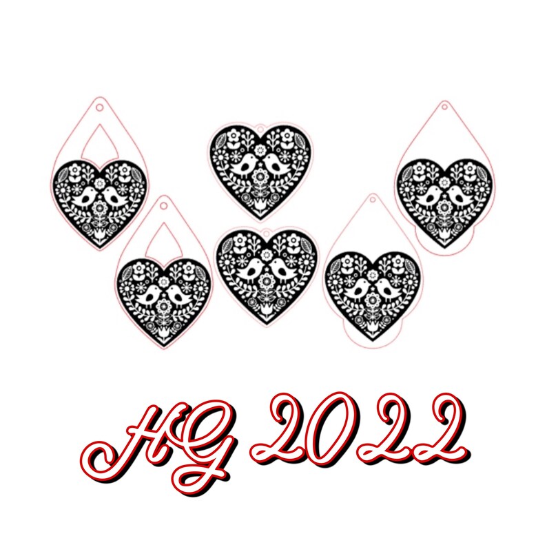 May include: Five black and white heart-shaped ornaments with a bird and floral design. The ornaments have a hole at the top for hanging. The text "HG 2022" is written in red below the ornaments.