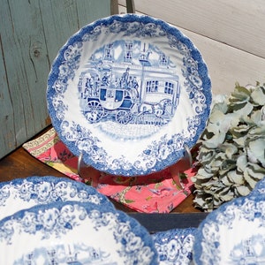 Puede incluir: Juego de seis cuencos de cerámica azul y blanco con un diseño vintage que presenta un carruaje tirado por caballos y un edificio. Los cuencos tienen un borde festoneado y un patrón floral.