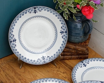 May include: Set of six white ceramic plates with blue floral designs. The plates have a scalloped edge and are arranged in a stack.