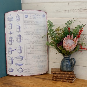 May include: A vintage enamelware price list with blue and white illustrations of various kitchenware, including teapots, coffee pots, and serving dishes. The list is titled "Email Blanc" and includes prices in French francs.