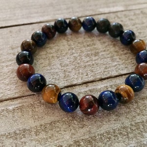 May include: A beaded bracelet with brown, blue, and gold tiger's eye beads.