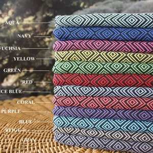 May include: A stack of 12 fabric swatches with a diamond pattern in various colors, including aqua, navy, fuchsia, yellow, green, red, ice blue, coral, purple, blue, beige, and gray.