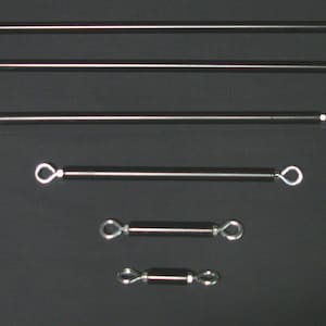 May include: Six silver metal rods of varying lengths with loops on each end.