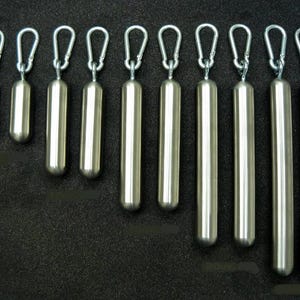 May include: Ten silver-colored metal weights with a carabiner clip at the top. The weights are cylindrical and range in size from small to large.