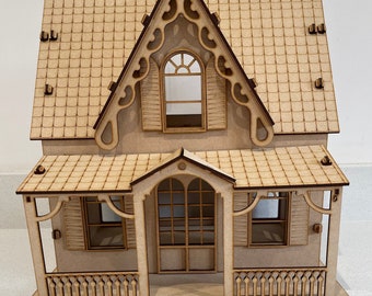 May include: A miniature wooden dollhouse with a detailed design. The house features a gabled roof, decorative trim, and a front porch with a railing. The windows and shutters add to the charm of this craft project.