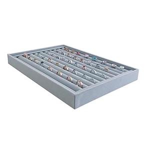 May include: A gray velvet ring display tray with 36 slots for storing rings. The tray is empty.