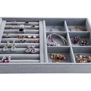 May include: A gray velvet jewelry organizer filled with various rings, earrings, and bracelets. The organizer has multiple compartments and slots to hold different types of jewelry. The jewelry includes silver, gold, and gemstone pieces.