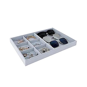 May include: A white velvet-lined jewelry tray with eight compartments. The tray is filled with various jewelry, including rings, earrings, and a bracelet. There are also three pairs of sunglasses in the tray.