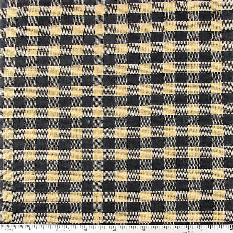 May include: Black and tan gingham fabric with a checkered pattern. The fabric is woven with a fine texture and has a slightly rustic look.