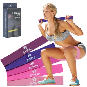 May include: Set of five resistance loop bands in purple, pink, and light pink colours. The bands are labelled with the text "ZAHBRO PRO FITNESS GEAR".