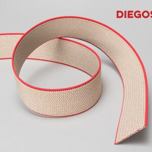 May include: Beige elastic band with a red trim. The band is made of a woven fabric and is rolled up. The brand name "DIEGOS" is printed in red on a white background.