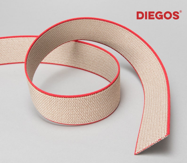 May include: Beige elastic band with a red trim. The band is made of a woven fabric and is rolled up. The brand name "DIEGOS" is printed in red on a white background.