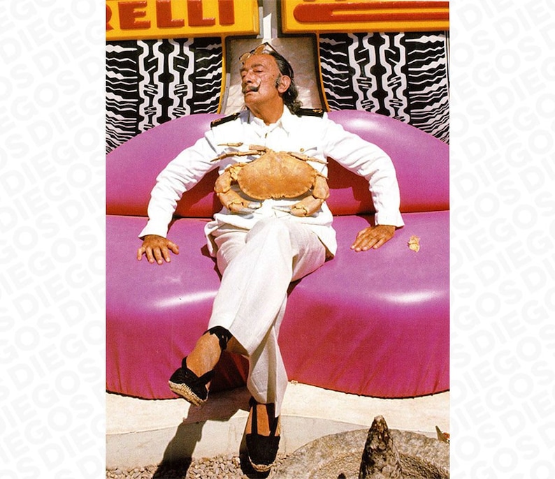 May include: A man in a white suit sits on a pink, curved sofa with a large crab on his chest. He is wearing black shoes and has a mustache.