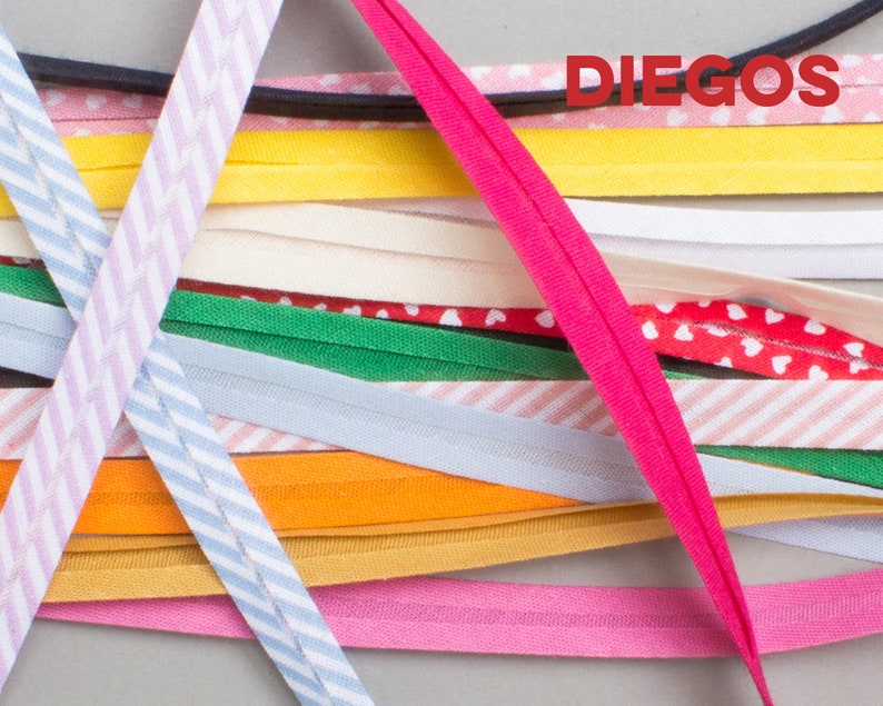 May include: A variety of colorful fabric trims, including striped, polka dot, and solid colors. The trims are arranged in a criss-cross pattern and the word "DIEGOS" is visible in the top right corner.