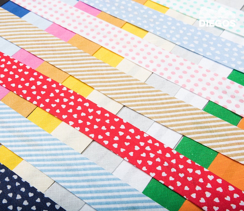 May include: Assortment of colourful patterned washi tapes. The tapes feature various designs, including stripes, polka dots, and hearts.