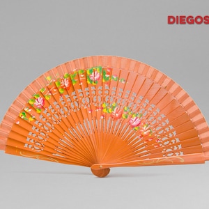 May include: A hand-painted orange wooden fan with floral designs. The fan is closed and has a carved wooden handle.