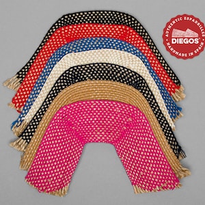 May include: A set of seven espadrille uppers in various colors, including black, red, blue, beige, and pink. The uppers are made of woven jute and have a fringe detail. The image includes a red circle with the text "Authentic Espadrilles Diegos Handmade in Spain".