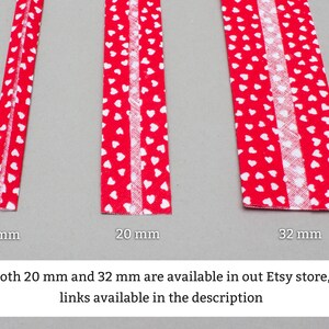 May include: Three red fabric trims with white heart patterns. The trims are 10 mm, 20 mm, and 32 mm wide. Both 20 mm and 32 mm are available in our Etsy store, links available in the description.